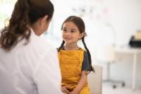 doctor and young patient sitting across from each other